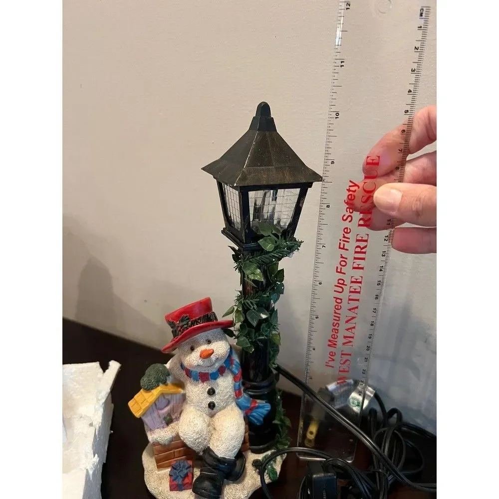 Snowman with flickering street lamp